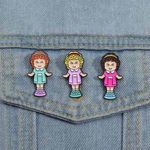 Three creative sisters enamel pins set styled on a denim jacket pocket for fashion display