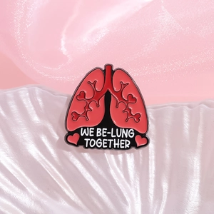 Pink lung and heart enamel pin with We Be-lung Together text on silk fabric