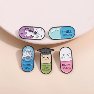 Five medical capsule enamel pins featuring creative pill shapes on a minimalist display