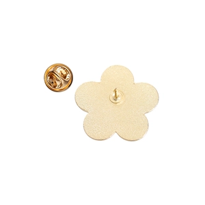 Detailed back view of golden flower brooch with secure metal butterfly clutch backing