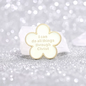White flower enamel brooch with 'I can do all things through Christ' golden quote
