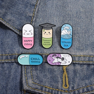 Macro detail of cartoon capsule enamel pins with various designs on blue denim fabric