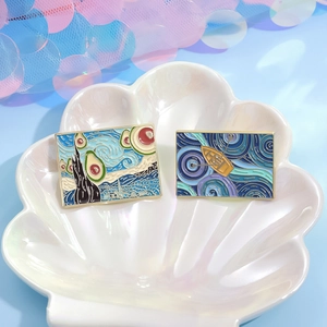 Artistic Van Gogh Starry Night enamel pins with avocado and boat motifs in a shell tray
