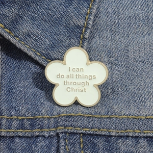 White flower enamel brooch with 'I can do all things through Christ' on denim background