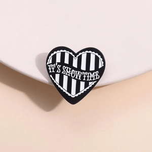 Modern black and white striped heart enamel pin with IT'S SHOWTIME slogan