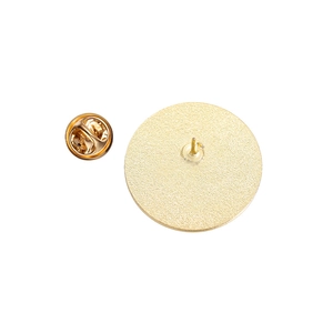 Macro view of golden geometric brooch back with textured finish and butterfly clasp