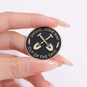 Minimalist round shovel enamel pin with gold plating and motivational quote