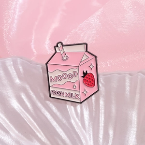 Cute strawberry milk box enamel pin with straw detail on pink silk background
