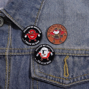 Detailed enamel pins featuring red cartoon meme characters on blue denim jacket fabric