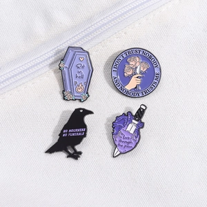 Set of 4 dark punk gothic enamel pins featuring purple coffin, raven, and heart motifs
