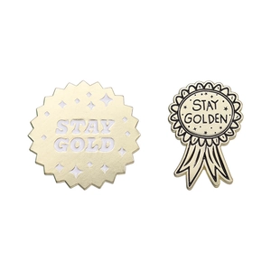 Minimalist gold metal medal brooch set featuring STAY GOLD and STAY GOLDEN star patterns