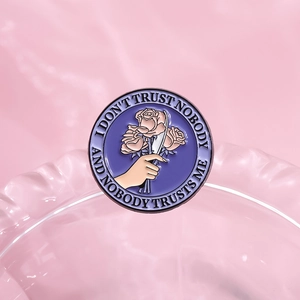 Gothic purple enamel pin with roses and knife design on a textured glass base