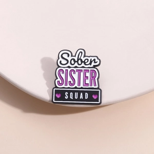 Creative enamel pin badge featuring Sober SISTER SQUAD text with purple hearts decor