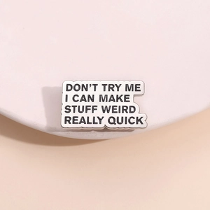 Minimalist enamel metal pin with funny English quote on a soft pink background