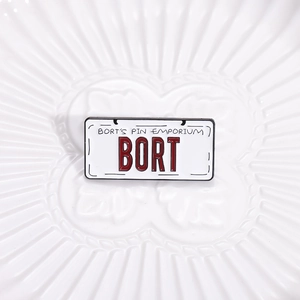 Retro BORT license plate enamel pin badge with BORT'S PIN EMPORIUM text on ceramic plate