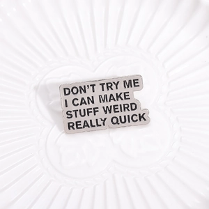 Silver metal badge with Don't Try Me I Can Make Stuff Weird Really Quick quote
