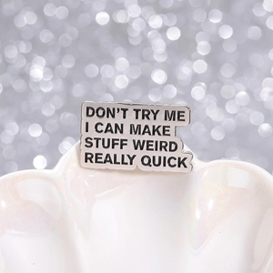Vintage style metal enamel brooch with weird quote on a white decorative shell