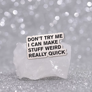 Retro metal brooch with funny English lettering pinned on white crystal decor