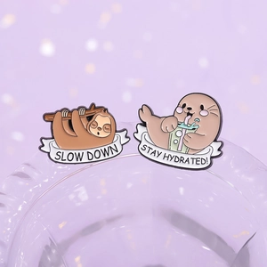 Creative sloth and sea otter enamel pins with stay hydrated and slow down quotes