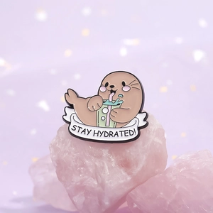 Cute enamel seal pin drinking bubble tea with Stay Hydrated text on pink crystal