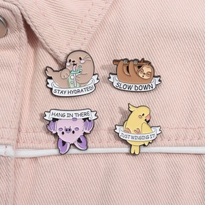 Close-up of four cute cartoon animal enamel pins on a pink denim jacket, showing detail