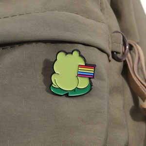Cute enamel frog brooch badge with rainbow flag on green lotus leaf, pinned on canvas bag