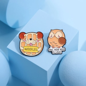 Cute enamel dog and owl pins with "OWL YOU NEED IS LOVE" text on blue background