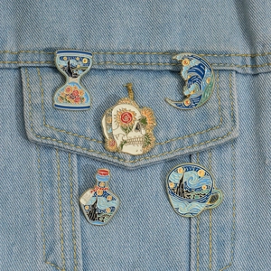 Artistic oil painting enamel pins featuring starry sky and moon motifs on denim jacket
