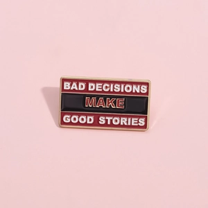 Rectangle enamel pin with 'Bad Decisions Make Good Stories' quote and gold border