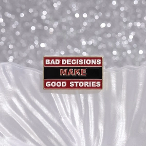 Rectangle enamel brooch badge with Bad Decisions Make Good Stories slogan on white ripple base