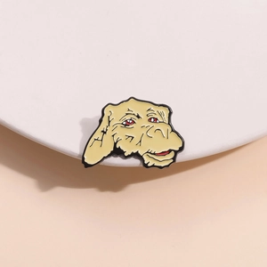 Close-up of a cartoon dog enamel pin with red eyes on a minimalist white stand