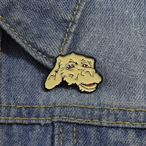 Detailed view of a lucky dragon enamel pin attached to a blue denim jacket collar