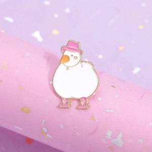 Cute enamel white duck pin with pink cowboy hat and boots on a glittery display stand
