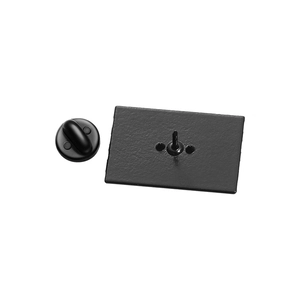 Detail view of the black matte metal brooch back featuring a needle and round clutch pin cap
