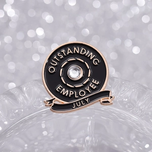 Golden July Outstanding Employee badge with black enamel and white rhinestone