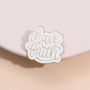 Enamel brooch with 'have faith' lettering in gold and white for bags and clothes