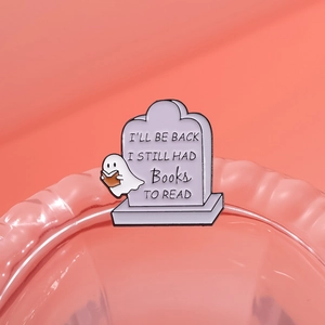 Cute ghost reading on tombstone enamel pin with 'I'll be back' quote on pink background