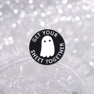 Cute ghost enamel pin with Get Your Sheet Together text on sparkling background