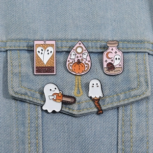 Set of cute Halloween ghost enamel pins on denim jacket including pumpkin and lovers tarot