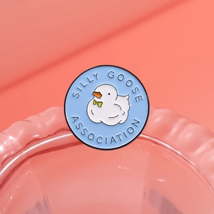 Round blue enamel badge featuring a cartoon white goose and SILLY GOOSE ASSOCIATION text