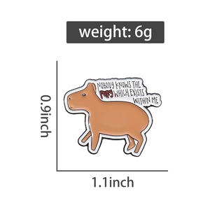 Detail of capybara enamel pin with text and dimensions showing 0.9 by 1.1 inches