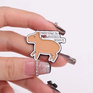 Close-up of cute Capybara enamel pin with humorous fury quote for backpack decor