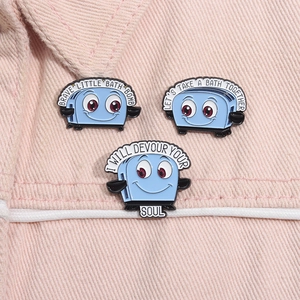 Detailed view of light blue toaster enamel pins on pink denim background with creative text