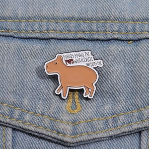 Cartoon capybara enamel pin with fury quote on denim jacket lapel accessory