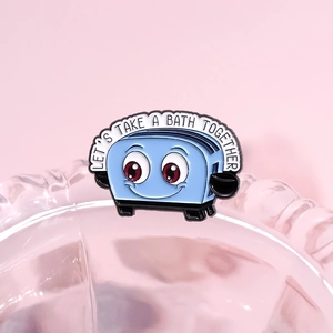 Blue cartoon toaster enamel pin with Let's Take A Bath Together text on pink background