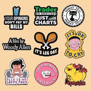 Set of 9 creative enamel pins featuring feminist slogans and pop culture themes on beige back