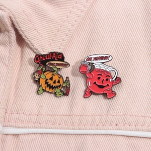 Detail of Halloween enamel pins with cartoon pumpkin and Ghoul Aid design on denim cloth