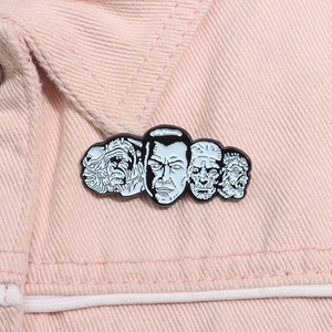 Detailed close-up of a horror-themed enamel monster badge on a pink denim jacket collar