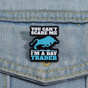 Cow day trader enamel pin with bull logo on denim jacket pocket for finance fans