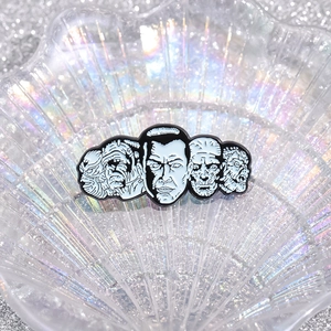 Dark punk alloy enamel pin featuring five classic horror movie monster character portraits